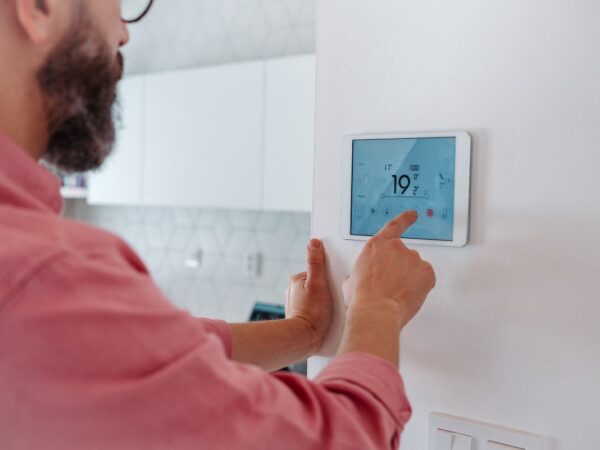 Man using smart thermostat in Kings Beach, California